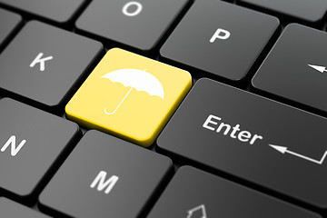 Image showing Safety concept: Umbrella on computer keyboard background
