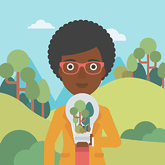 Image showing Woman with lightbulb and trees inside.