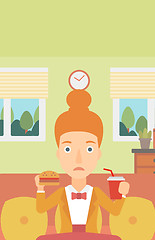 Image showing Woman eating hamburger. 