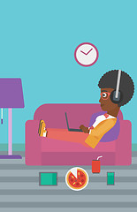Image showing Woman lying on sofa with many gadgets.