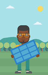 Image showing Man holding solar panel.