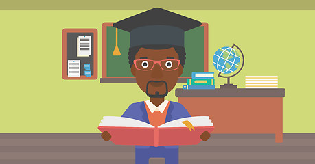 Image showing Man in graduation cap holding book.