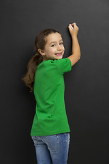 Image showing Girl writing in a blackboard