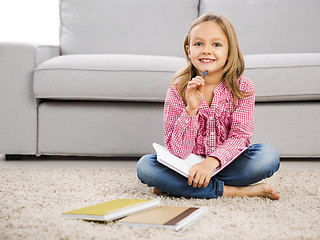 Image showing Little girl making homework