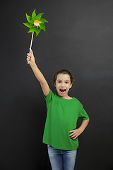 Image showing Little girl holding a windmill