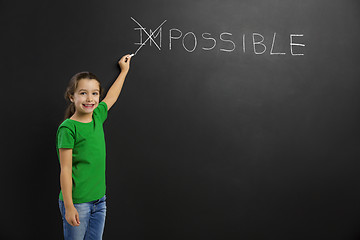 Image showing Girl writing in a blackboard