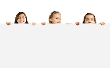 Image showing Little girls holding a white board