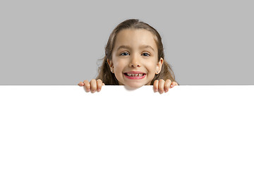 Image showing Cute girl holding a blankboard