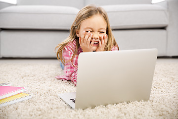 Image showing Little girl working with a laptop