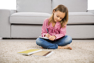 Image showing Little girl making homework