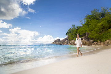 Image showing A beautiful woman walking on the beach