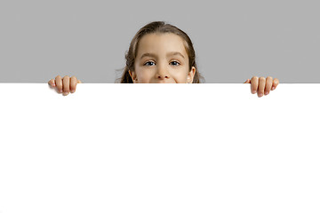 Image showing Cute girl holding a blankboard