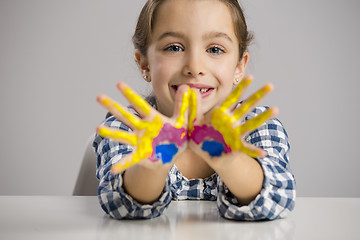 Image showing Little girl with hands in paint