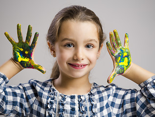 Image showing Little girl with hands in paint