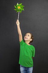 Image showing Little girl holding a windmill