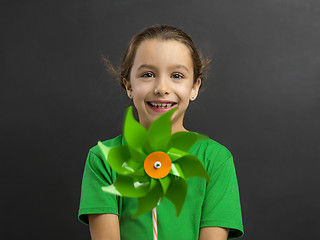 Image showing Little girl holding a windmill