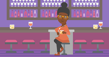 Image showing Woman sitting at bar.