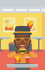 Image showing Man eating hamburger. 