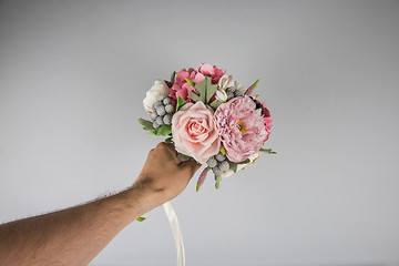Image showing male hand giving wedding bouquet