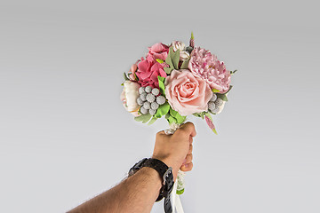Image showing male hand giving wedding bouquet