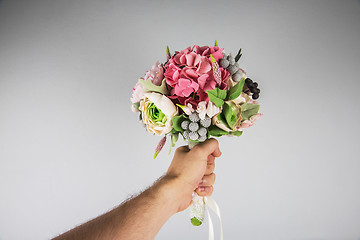 Image showing male hand giving wedding bouquet