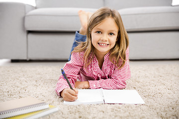 Image showing Little girl making homework