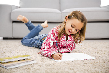 Image showing Little girl making homework