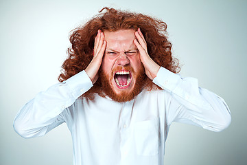 Image showing Stressed businessman with a headache