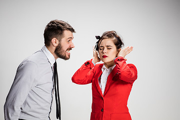 Image showing The business man and woman communicating on a gray background