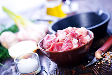 Image showing raw meat and pan on a table