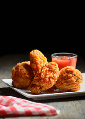 Image showing fried chicken drumstick and ketchup