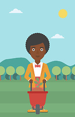 Image showing Woman with plant and wheelbarrow.