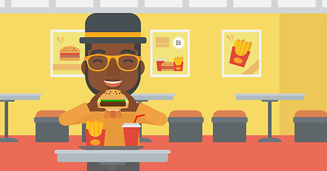 Image showing Man eating hamburger. 