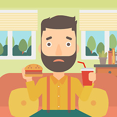 Image showing Man eating hamburger. 