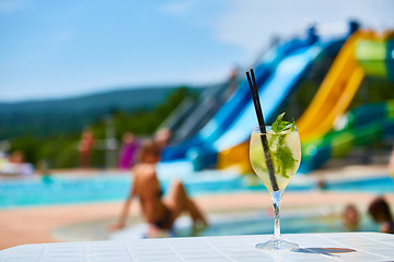 Image showing Close up Cocktail margaritas with lime near the swimming pool