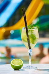 Image showing Close up Cocktail margaritas with lime near the swimming pool