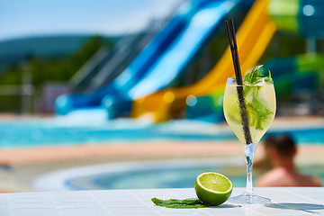 Image showing Close up Cocktail margaritas with lime near the swimming pool