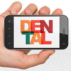 Image showing Health concept: Hand Holding Smartphone with Dental on  display