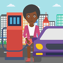 Image showing Woman filling up fuel into car.