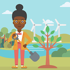 Image showing Woman plants tree.