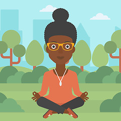 Image showing Business woman meditating in lotus pose.