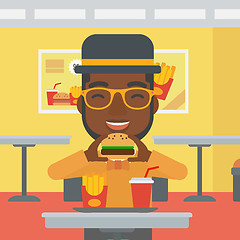 Image showing Man eating hamburger. 