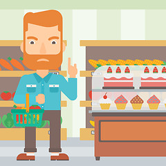 Image showing Man holding supermarket basket.