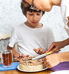 Image showing mom with son cut a birthday cake