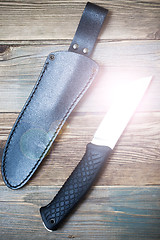 Image showing shiny hunting knife and leather scabbard