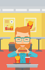 Image showing Man eating hamburger. 