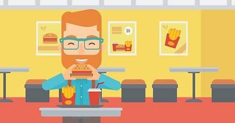 Image showing Man eating hamburger. 