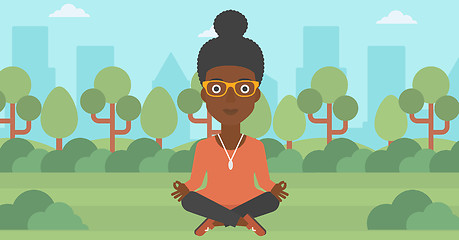 Image showing Business woman meditating in lotus pose.