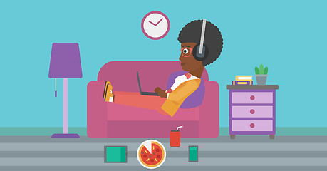 Image showing Woman lying on sofa with many gadgets.