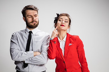 Image showing The business man and woman communicating on a gray background